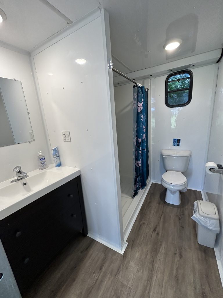One of four private washrooms in our washroom trailer, complete with flush toilets, hot-water showers and a vanity.